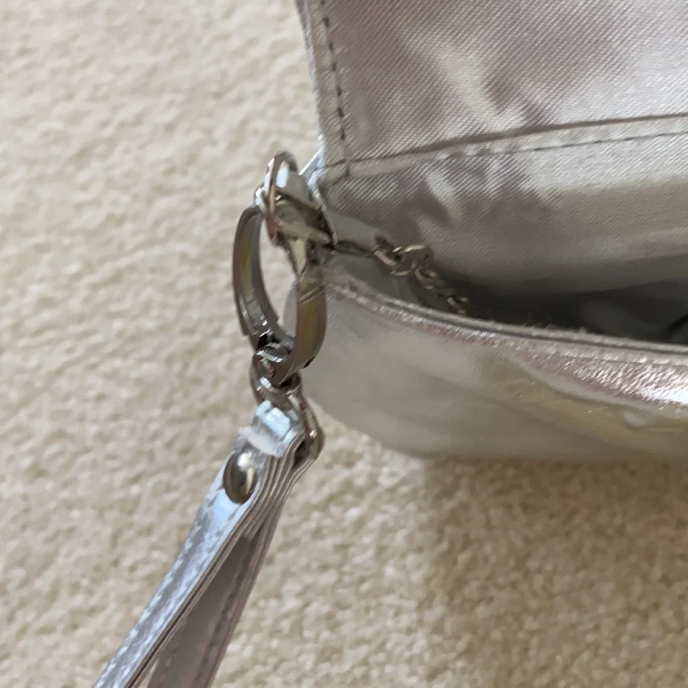 Silver clutch with removable chain and wrist strap